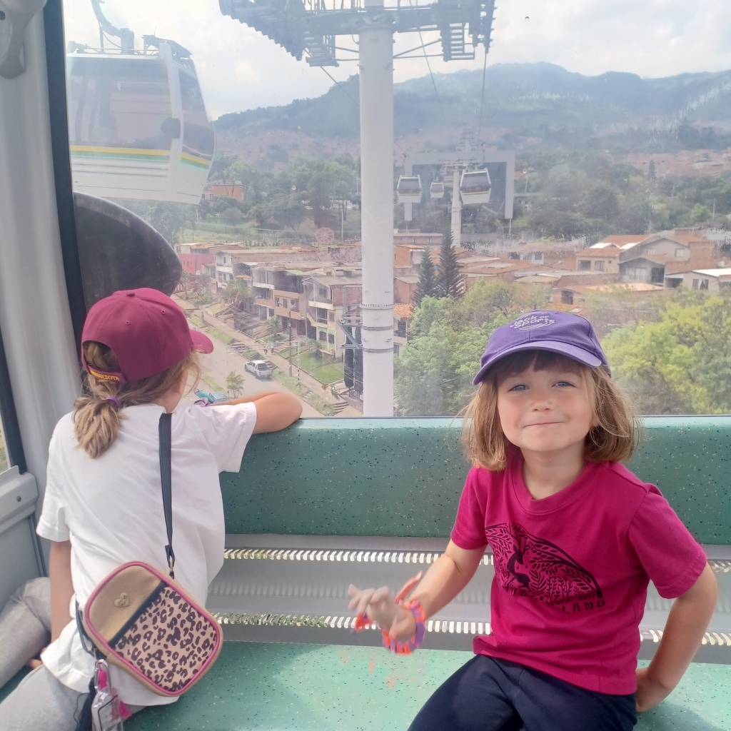Two children riding the cable cars in Medellin